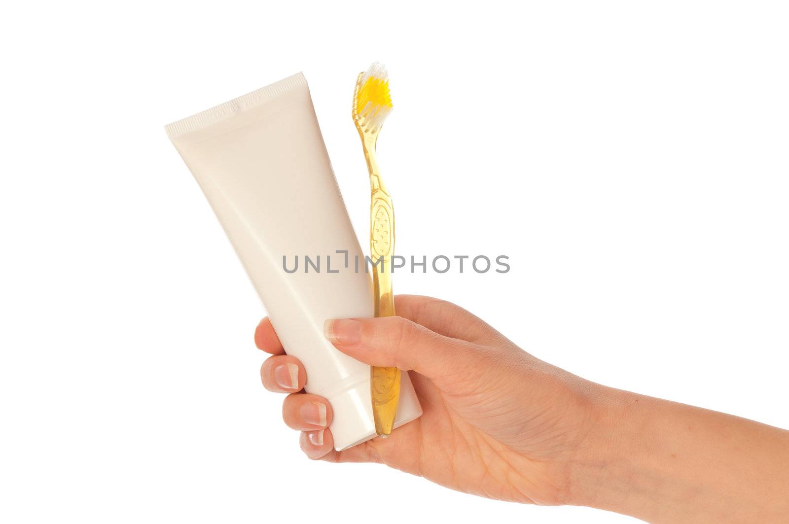 Tooth-paste and brush at in the girl's hand