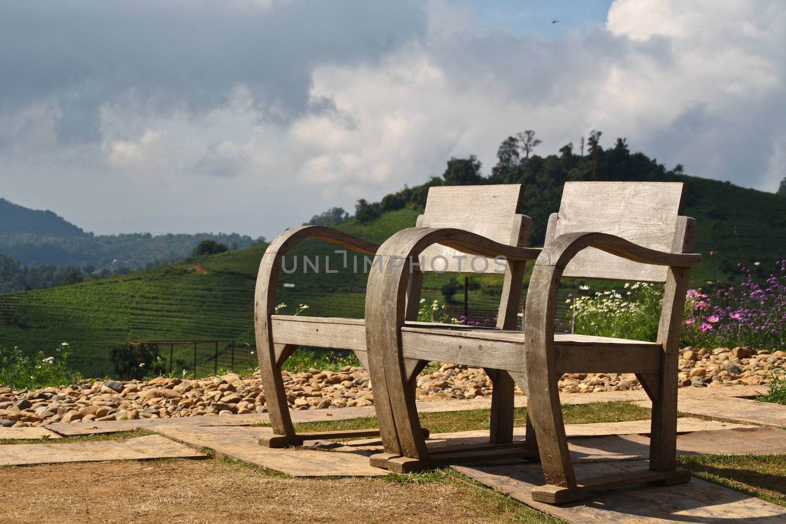 A pair of wooden chairs. High mountains in the park, I love it.