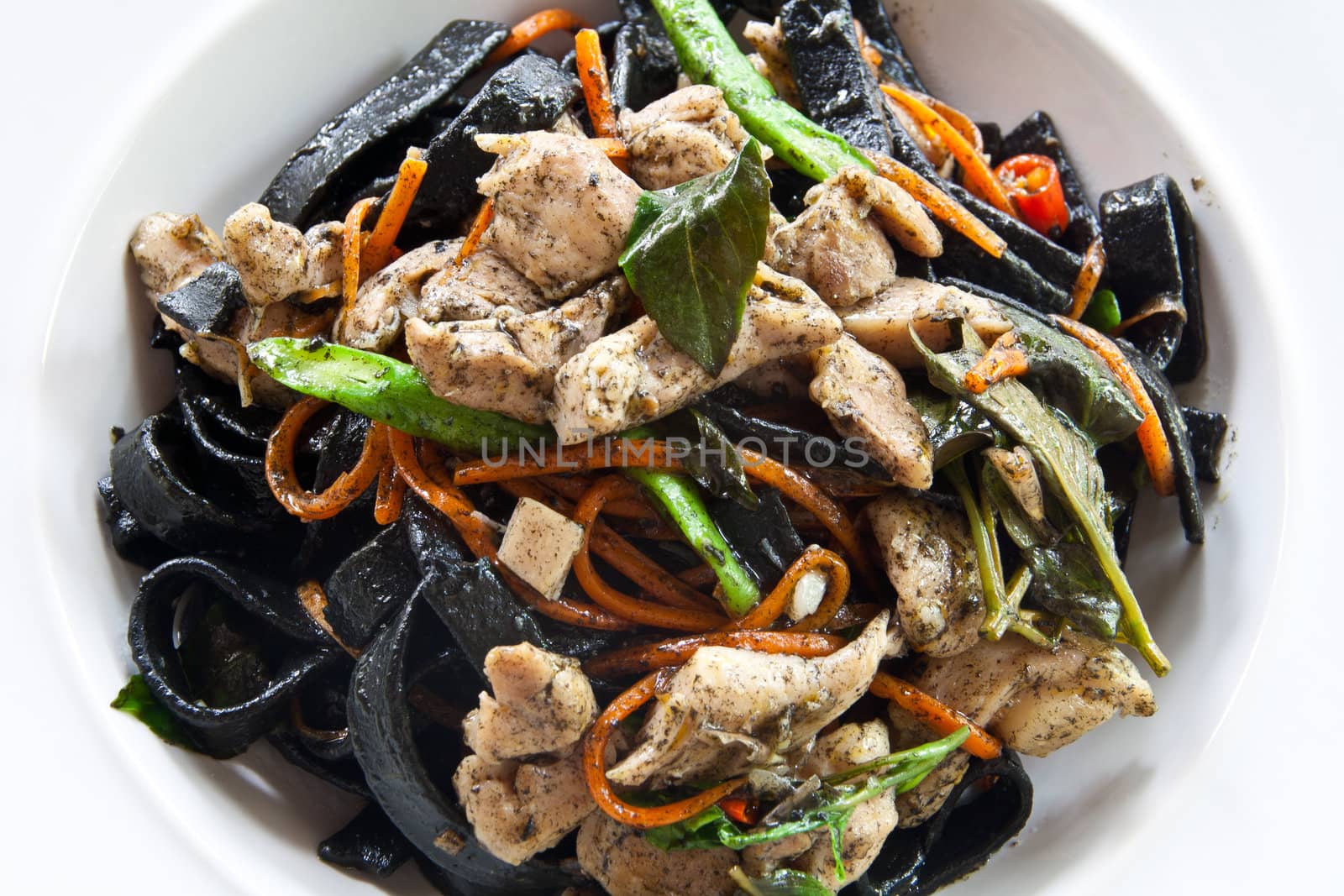 Stir in spaghetti, black lines. A spicy. thai style.