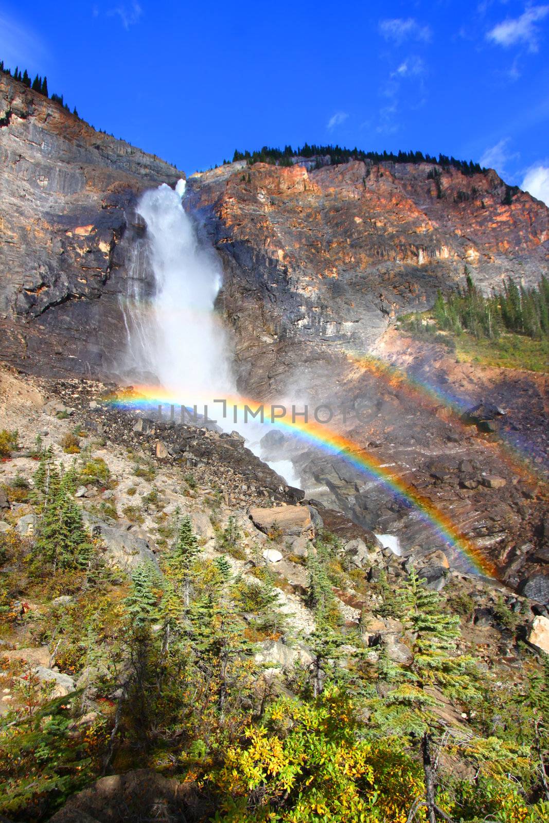 Double rainbows in the mist below Takakkaw Falls of Yoho National Park in Canada.