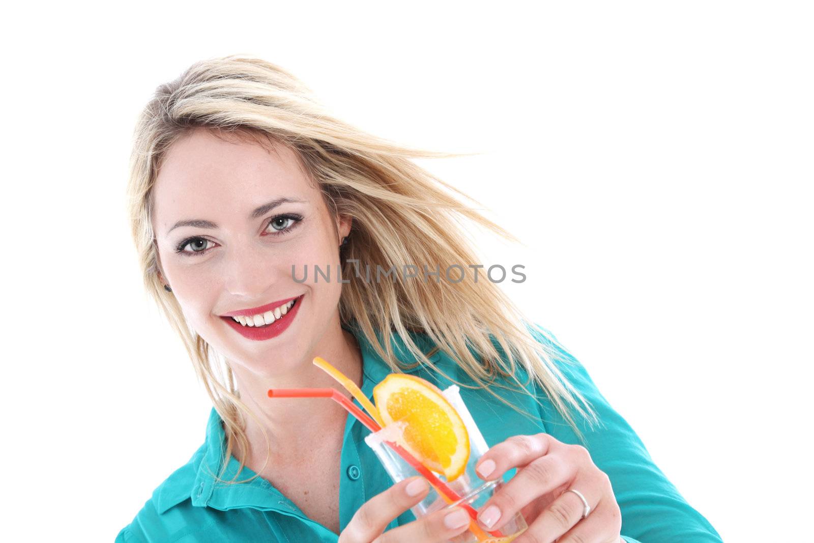 Beautiful carefree woman with the wind in her hair and a joyful smile holding a glass of cocktail on a tropical vacation Beautiful carefree woman with the wind in her hair and a merry smile holding a glass of cocktail on a tropical vacation 