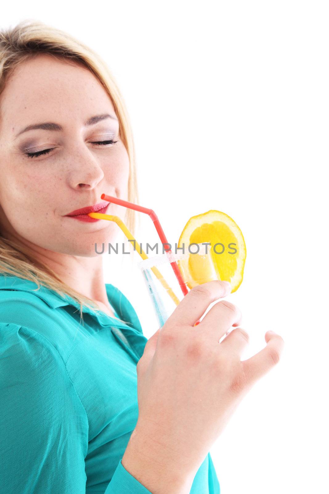 Blissful woman in a turquoise top drinking orange cocktail with her eyes closed as she savours every last drop on her summer vacation 