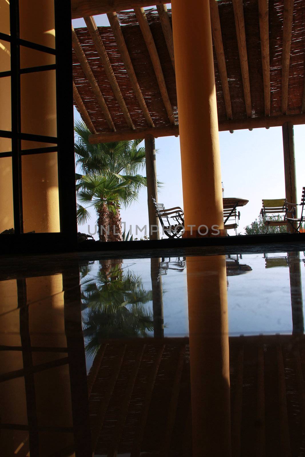 nice view with marble floor and pillar with palms