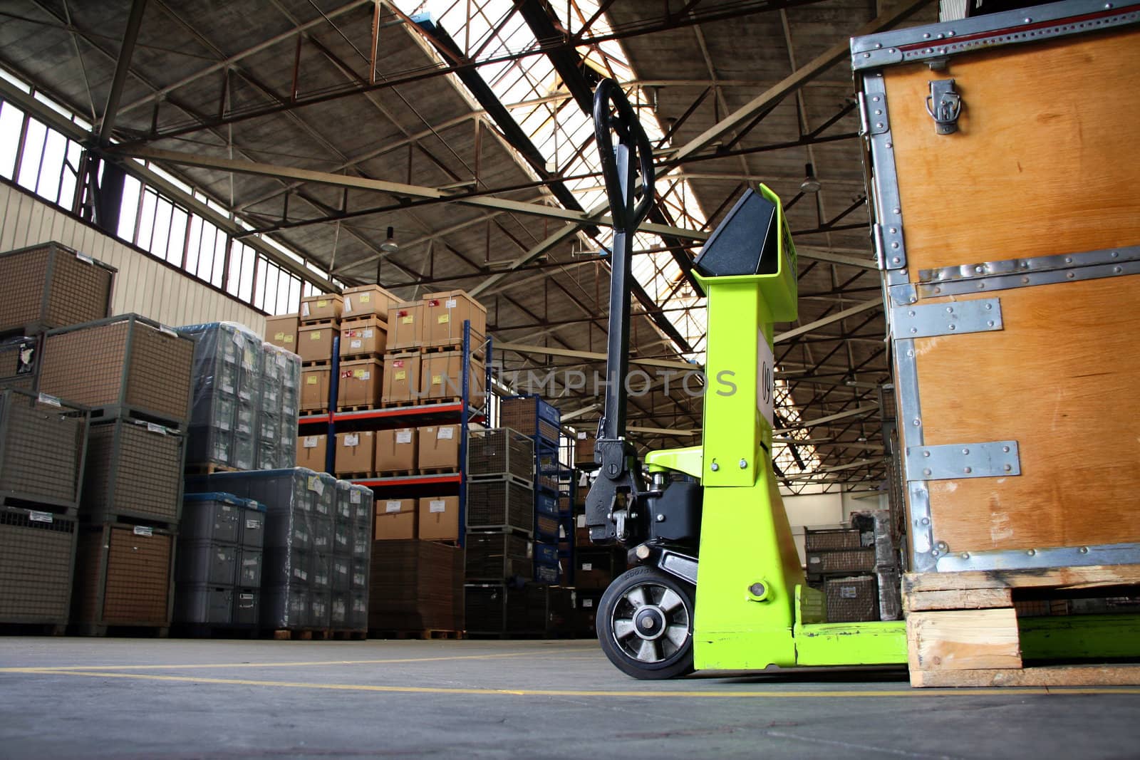 yellow pallet jack in the industrial warehouse