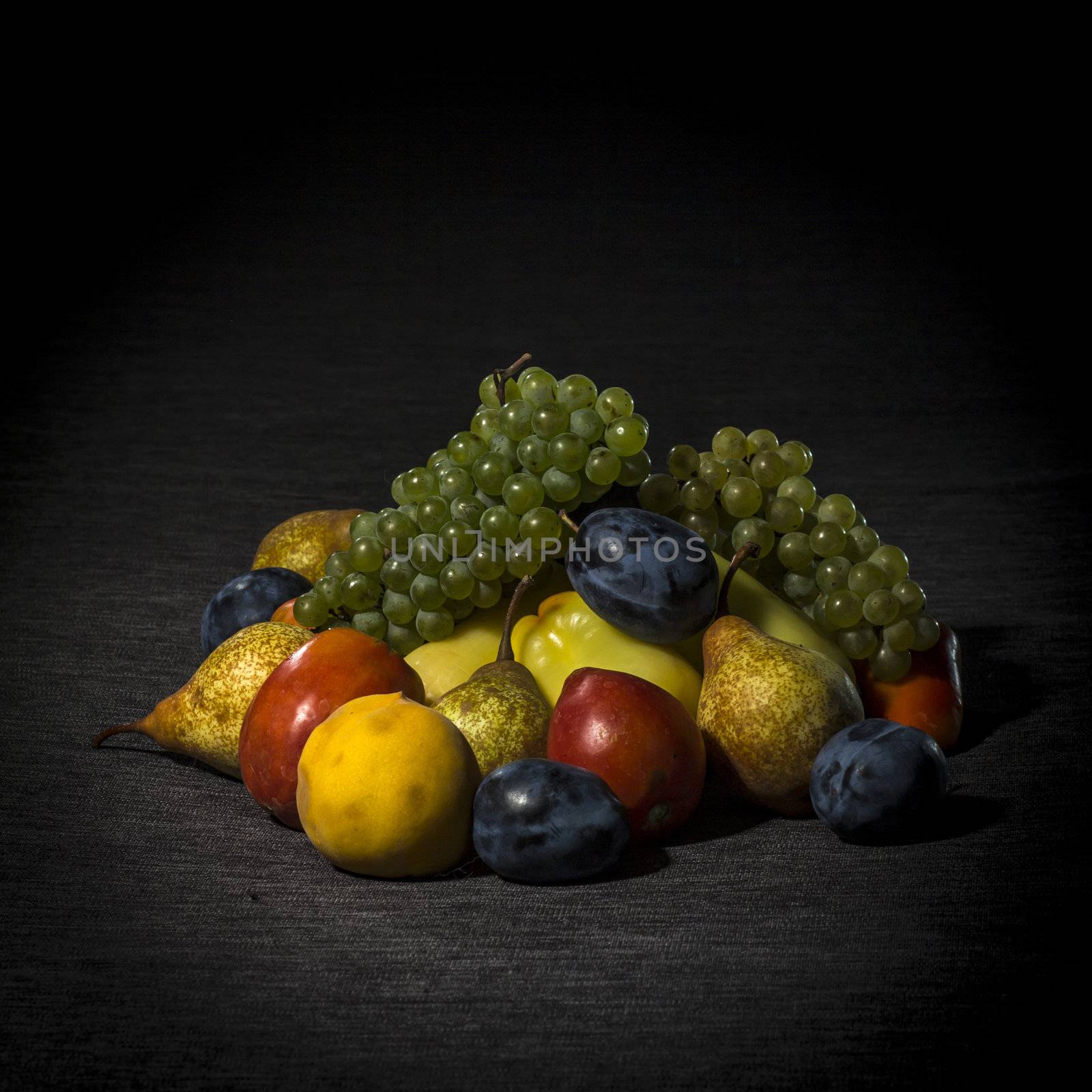 Organic fruits and vegetables on dark background