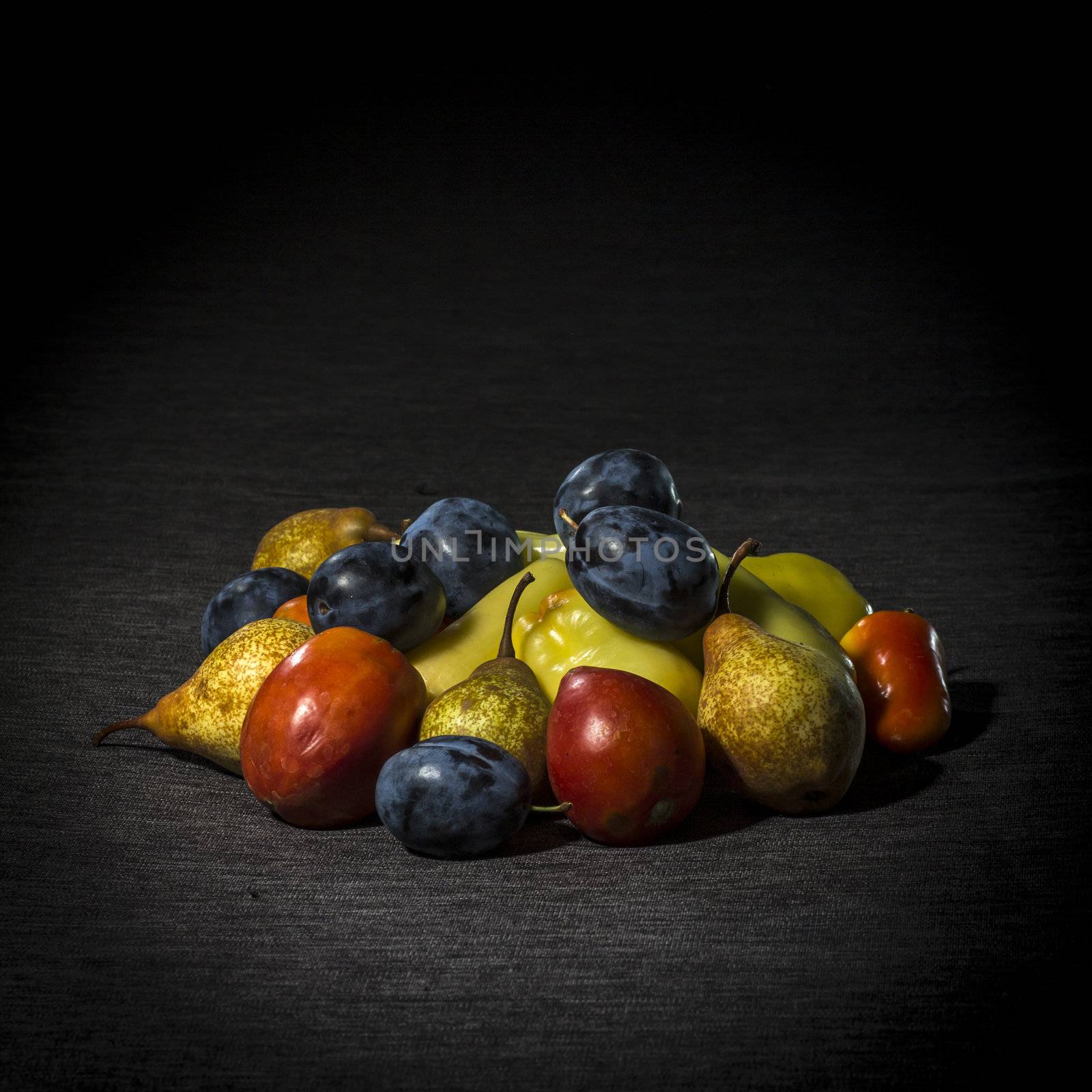 Organic fruits and vegetables on dark background