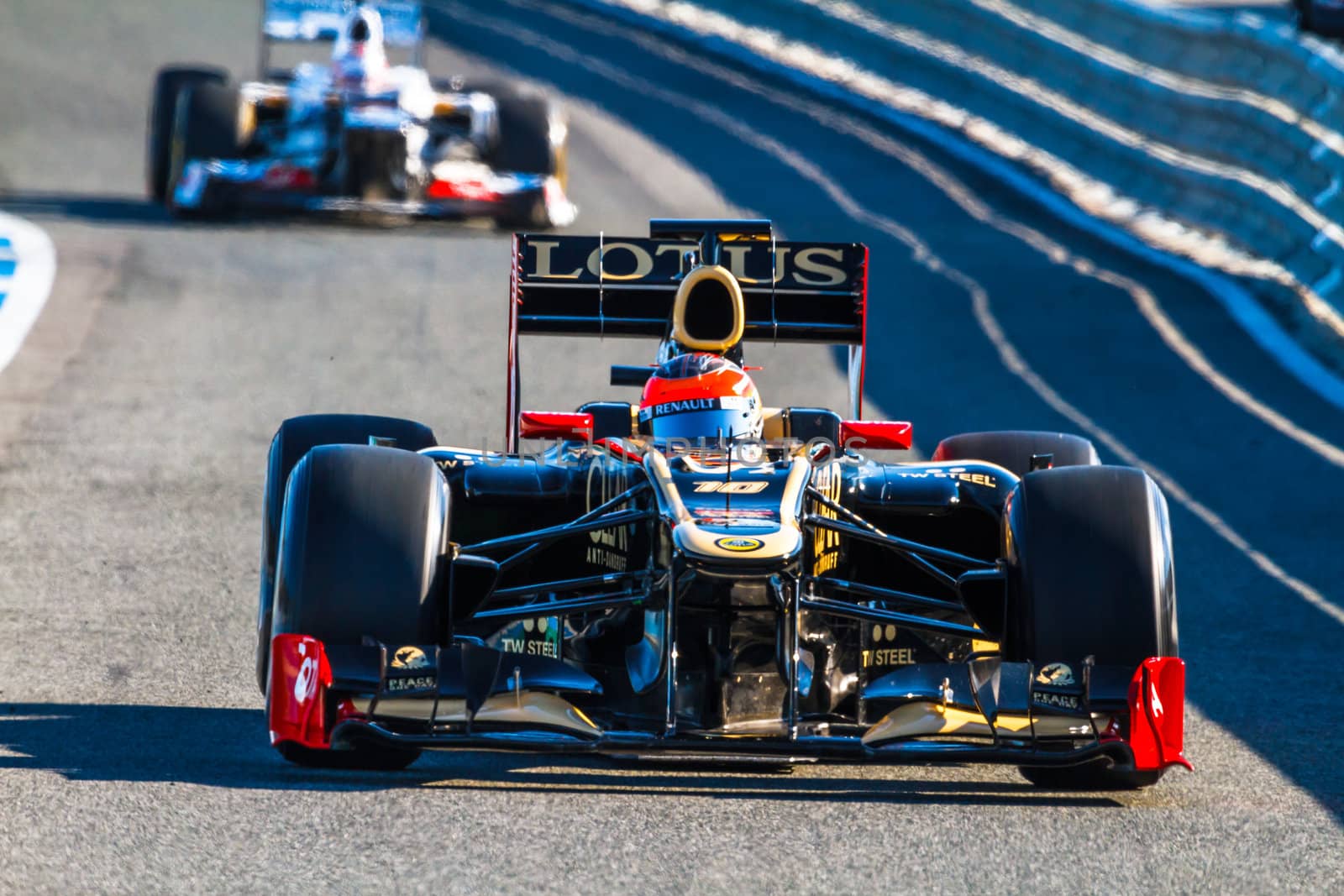 JEREZ DE LA FRONTERA, SPAIN - FEB 10: Romain Grosjean of Lotus Renault F1 leaving the pit followed by Kobayashi of Sauber on training session on February 10 , 2012, in Jerez de la Frontera , Spain