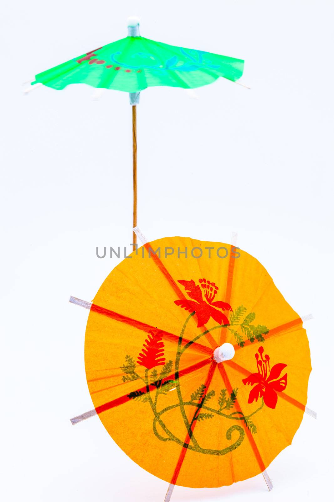 Two cocktail umbrellas on a white background