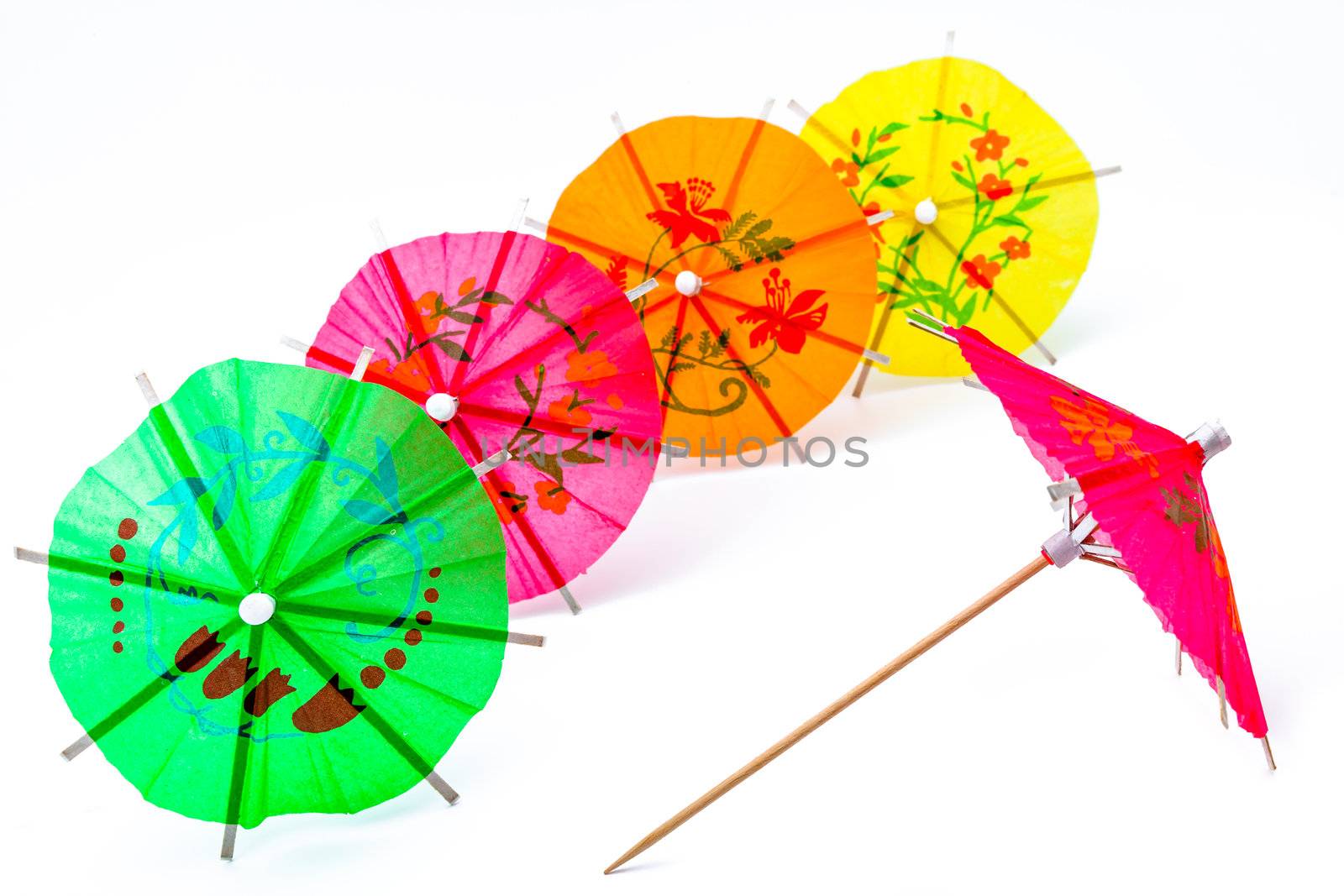 Several cocktail umbrellas on a white background