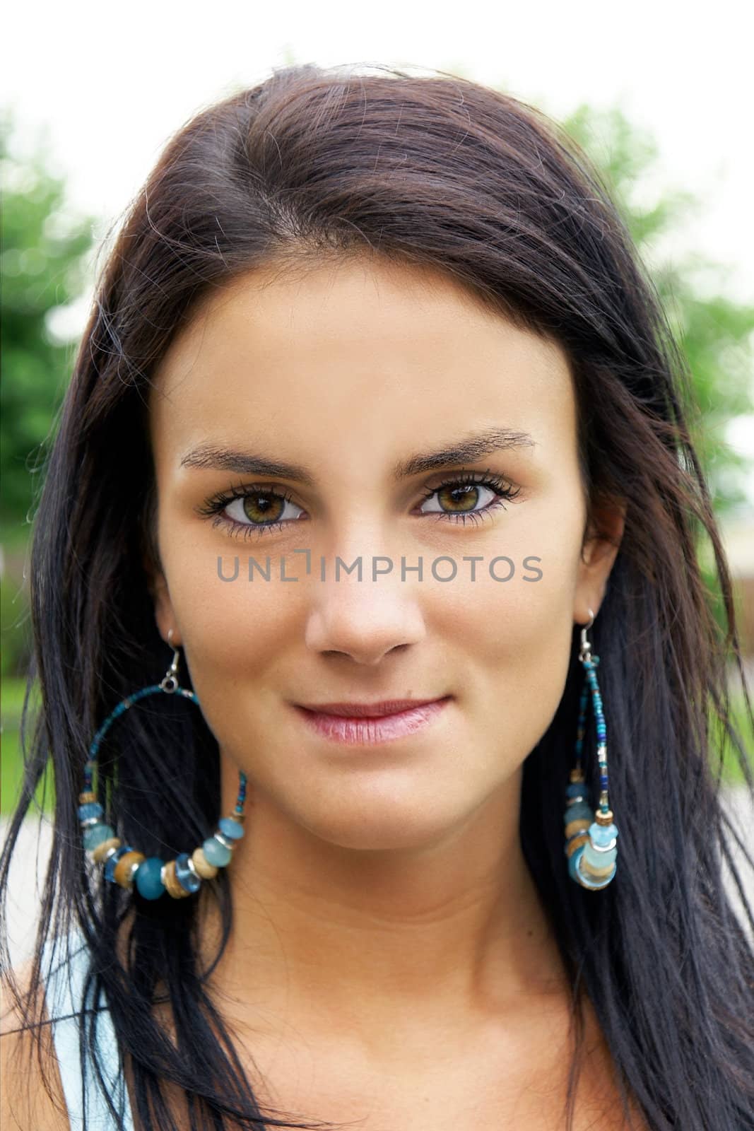 Portrait of a beautiful brunette young woman with girl next door look, could be of ethnic origin, native american or latino.