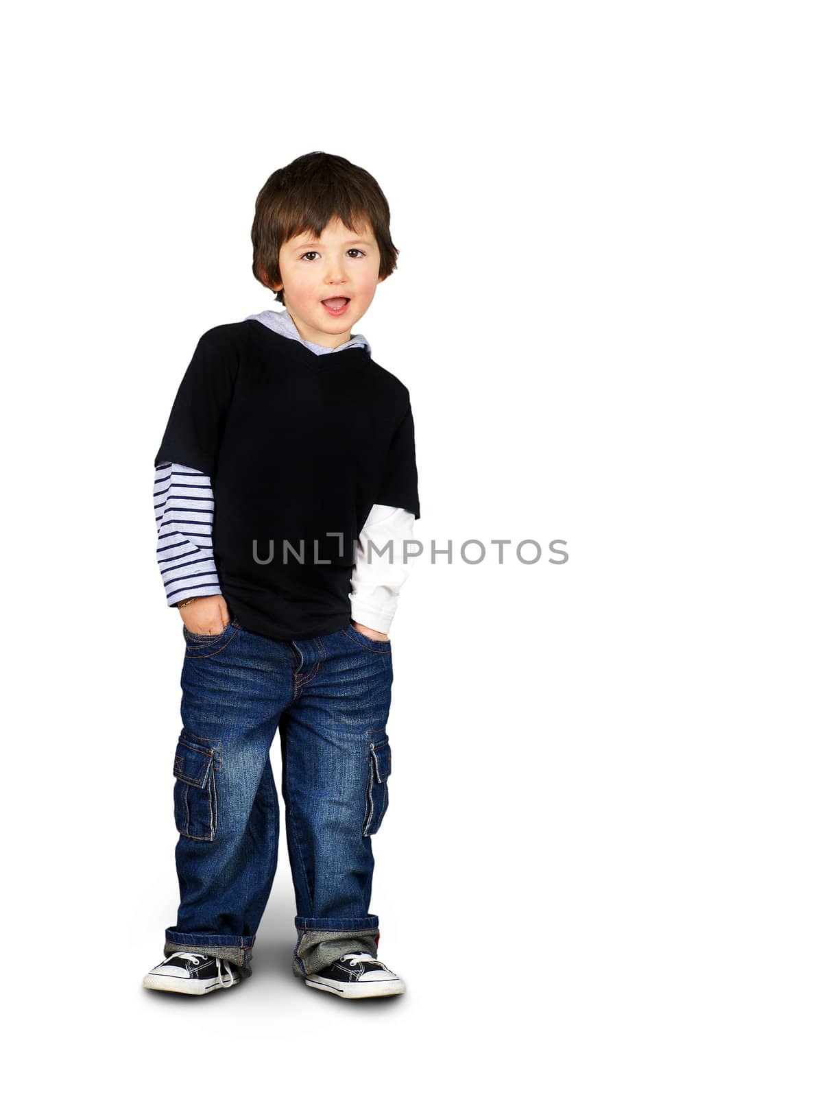 Cute and hip little boy leaning and speaking, hands in the pockets isolated over white background as copy space ready for text or other advertisement.