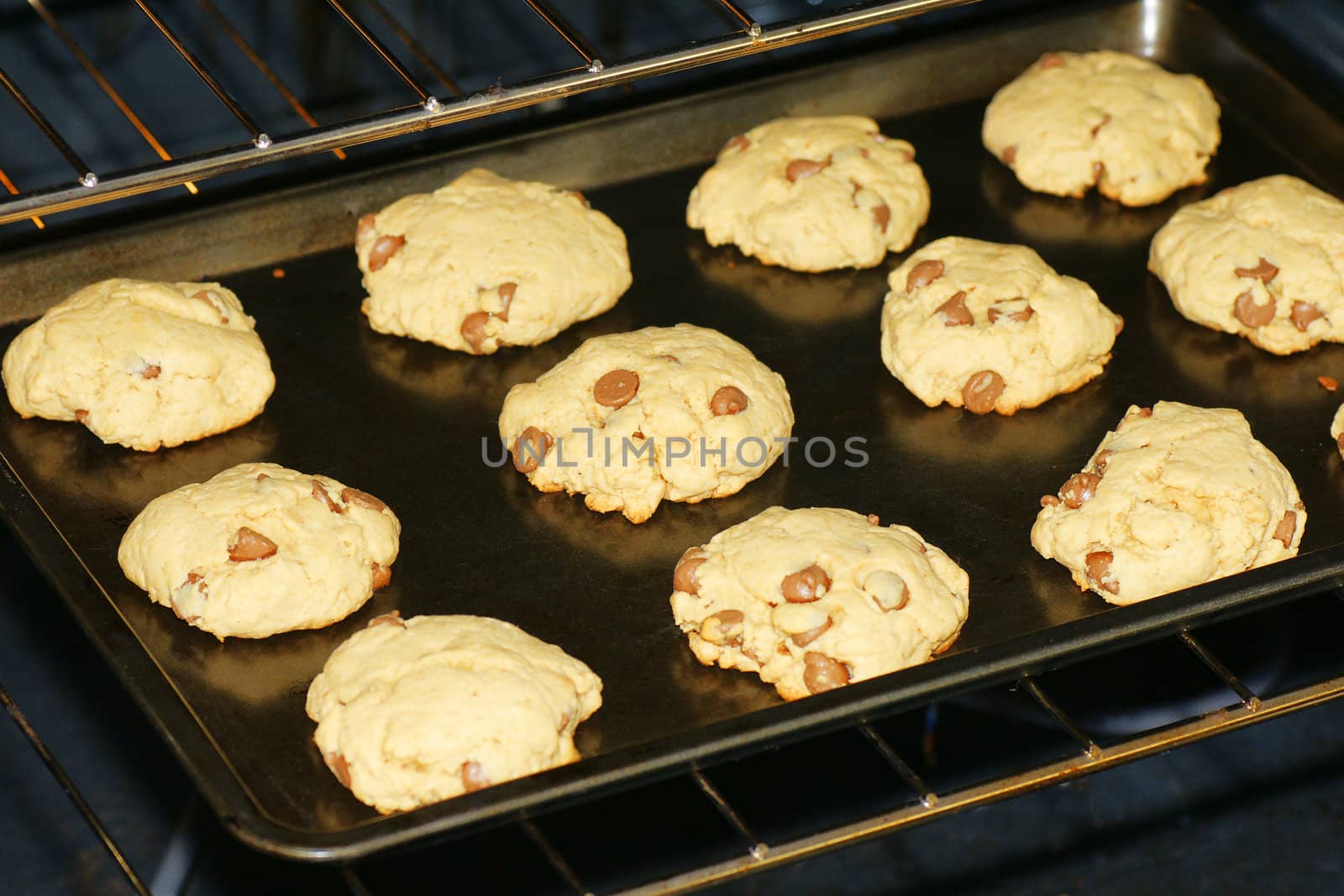 Baking delicious homemade chocolate chip cookies in a non stick pan and oven.