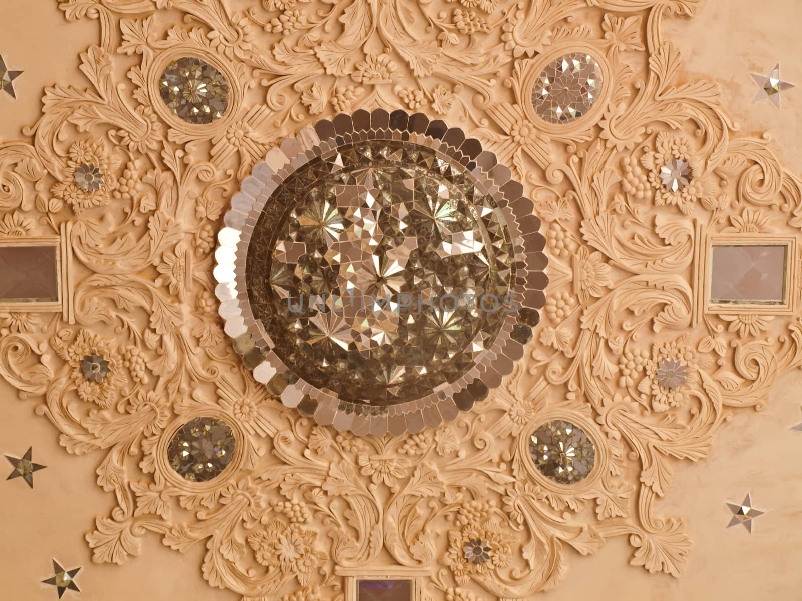 Closeup of white stucco and mirror decoration in the interior ceiling of historic old house in Kashan, Iran
