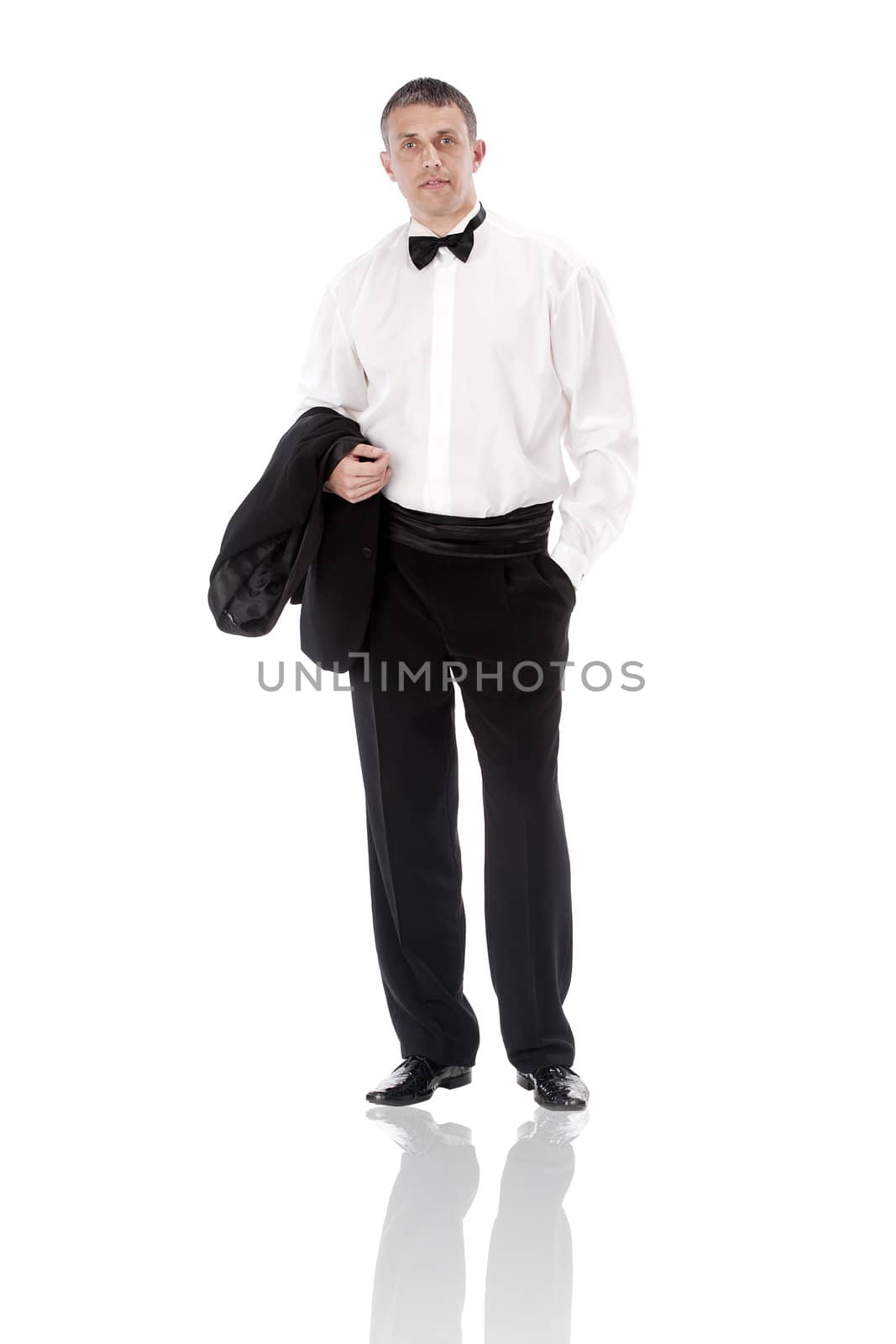 The elegant man in a classical tuxedo on a white background