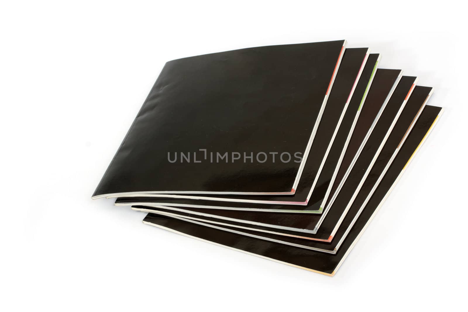 Stack of black covered magazines on white background
