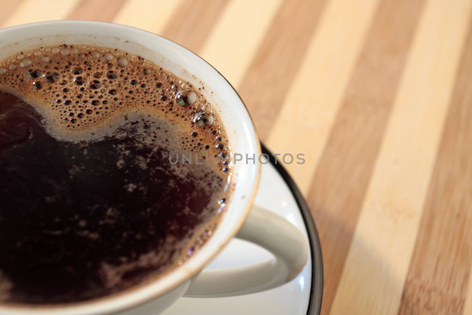 Coffee on cup on striped table 