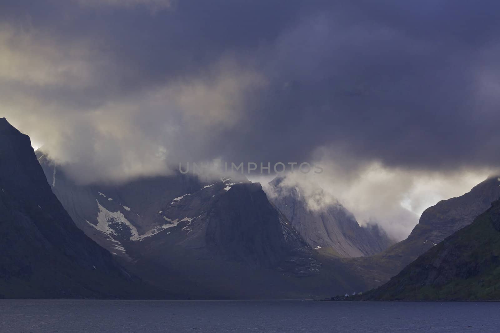 Norwegian fjord Reinefjorden on Lofoten islands, Norway, with heavy clouds