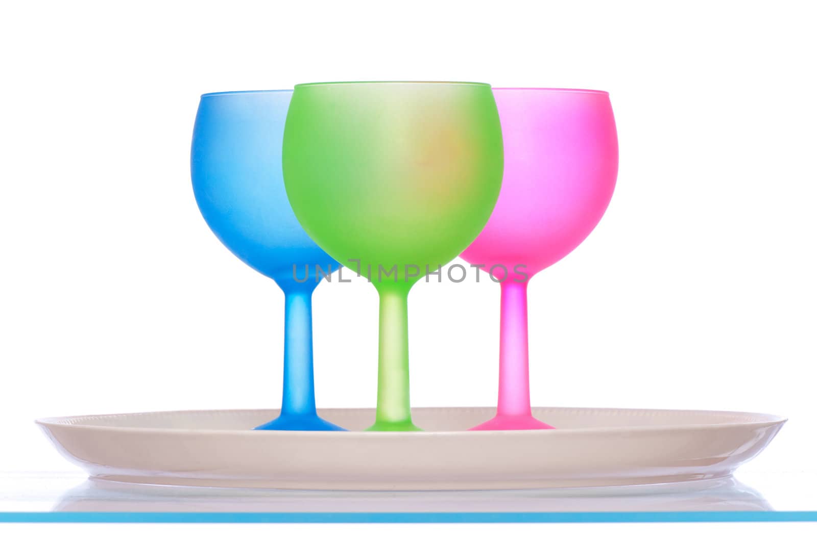 three colored wine glasses for cocktails on the tray for party