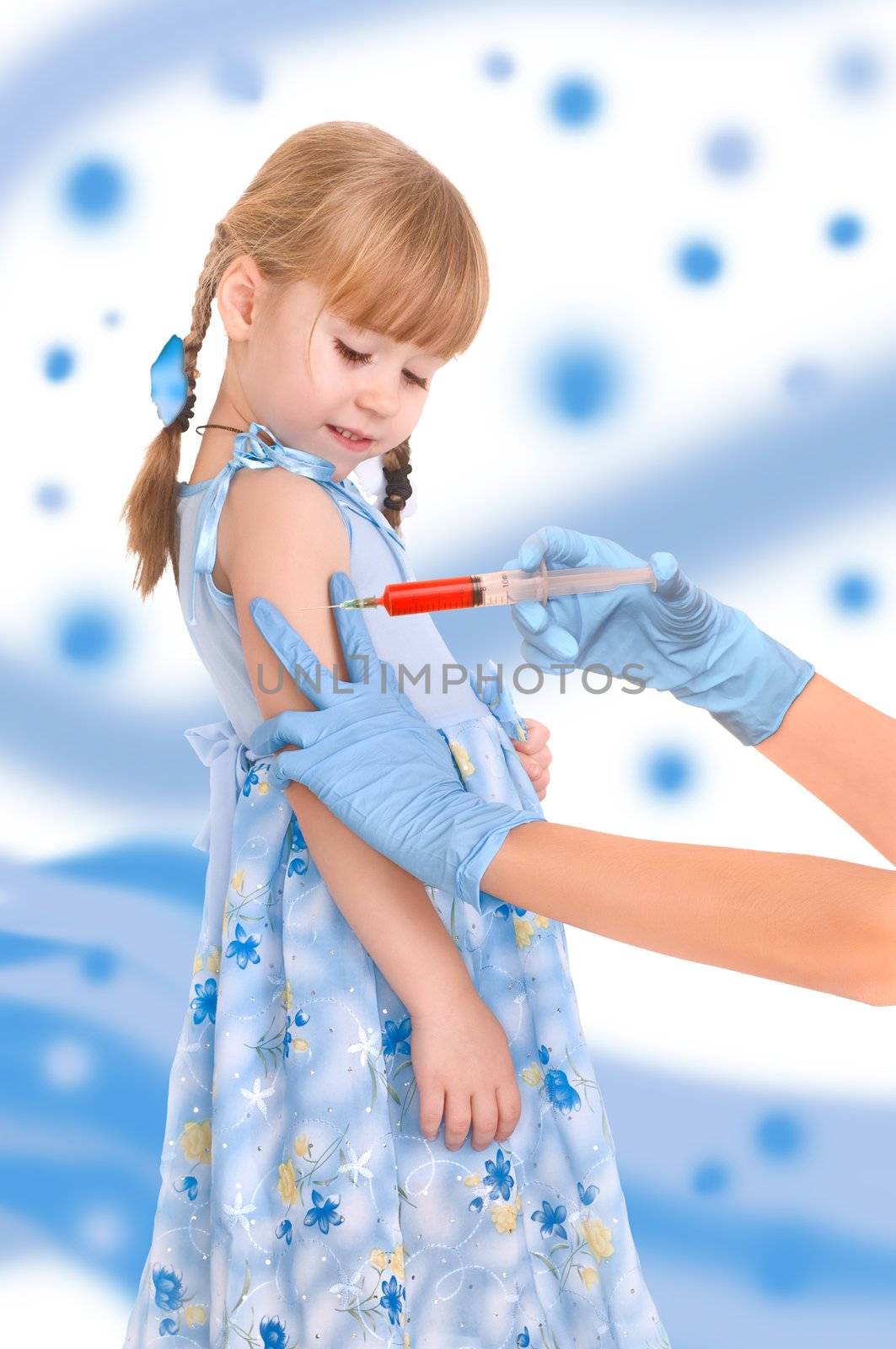 doctor making a vaccination for a child on blue background