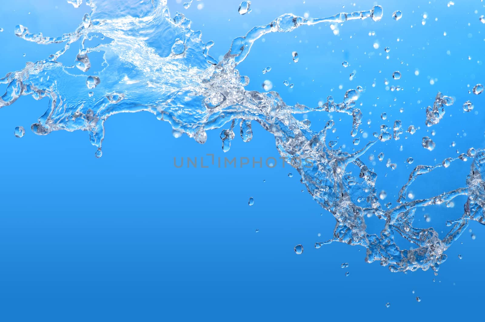 pouring tropical blue sea water in a glass aquarium