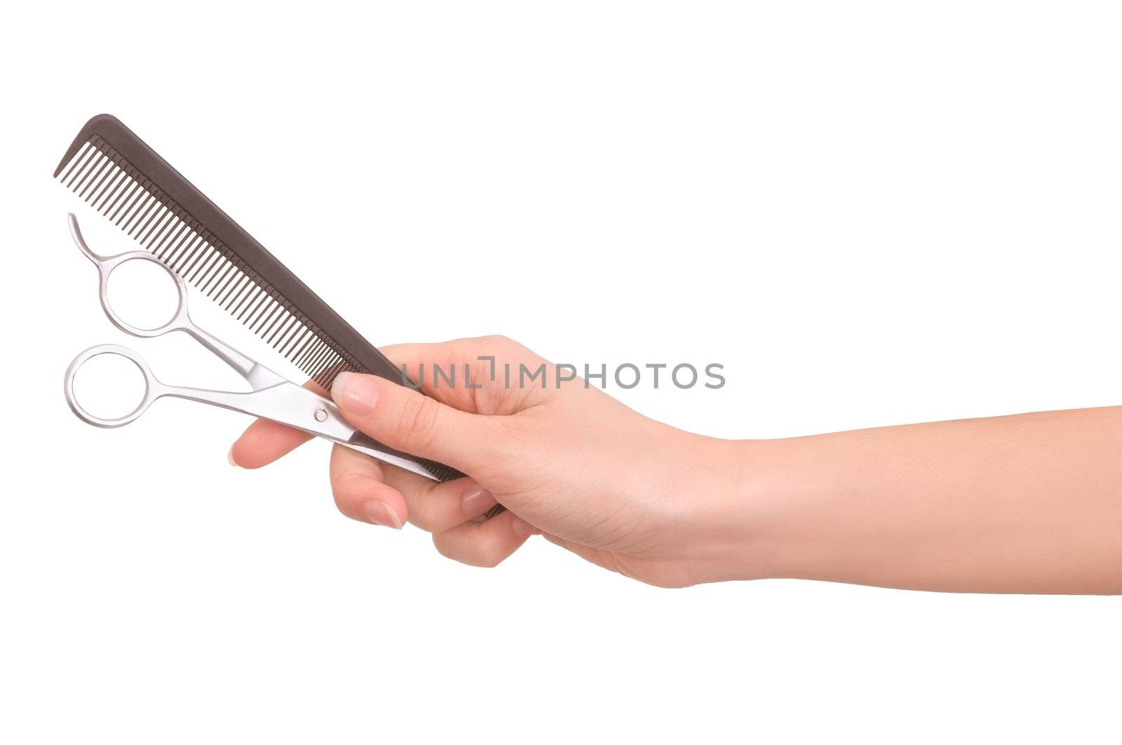 Scissors and comb in the hand on white background