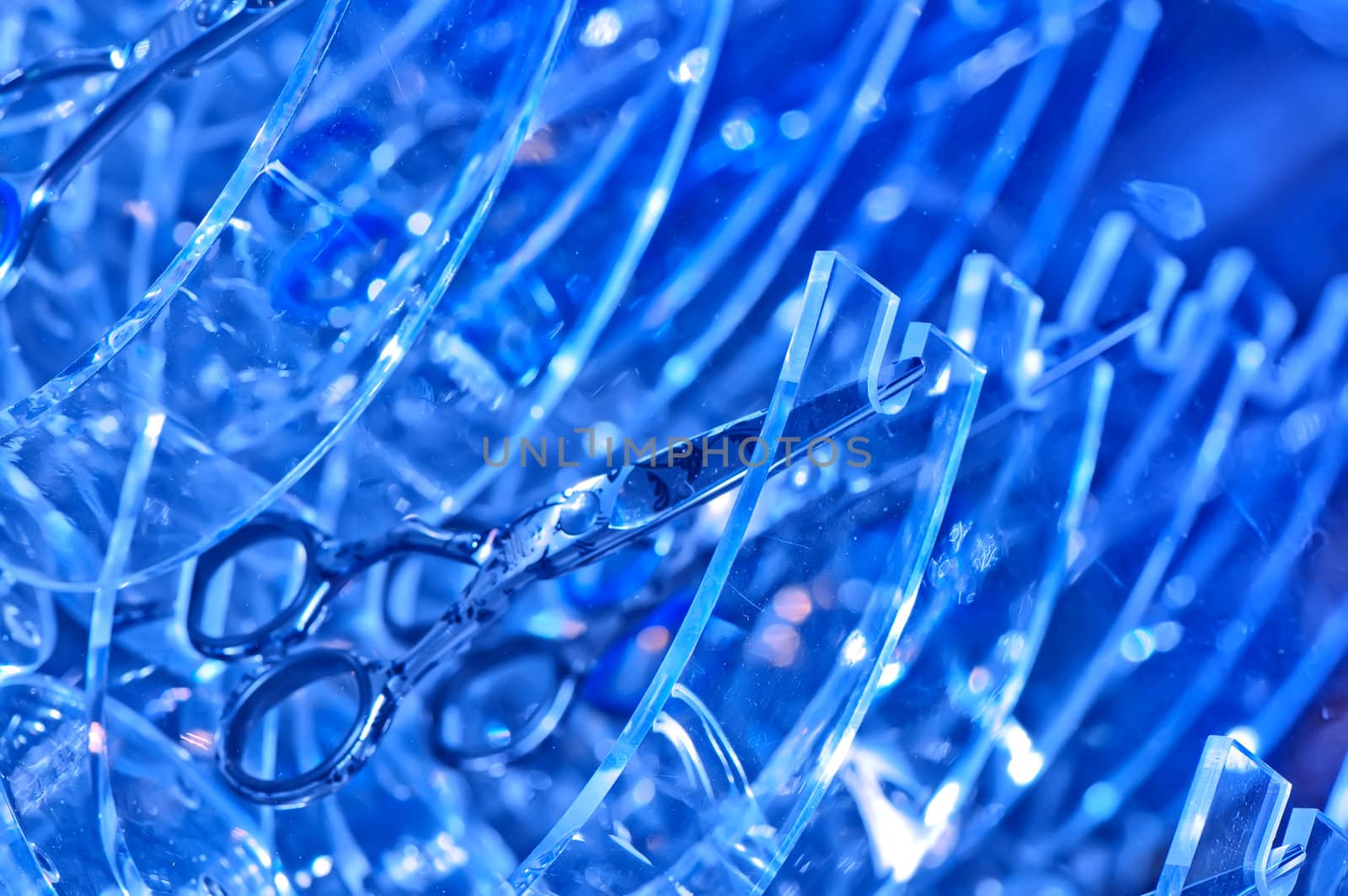 scissors on the blue abstract background for making hairdressing