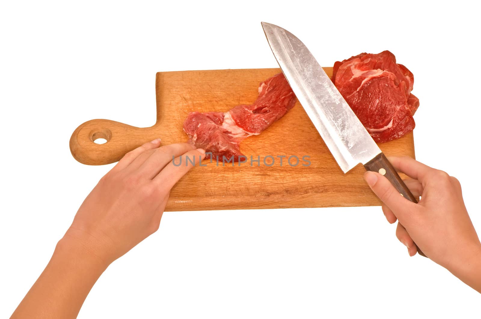 Slices of the meat on the board with knife on the kitchen