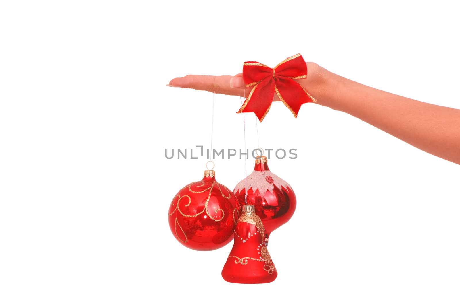 three Christmas-tree balls in the hand on white background