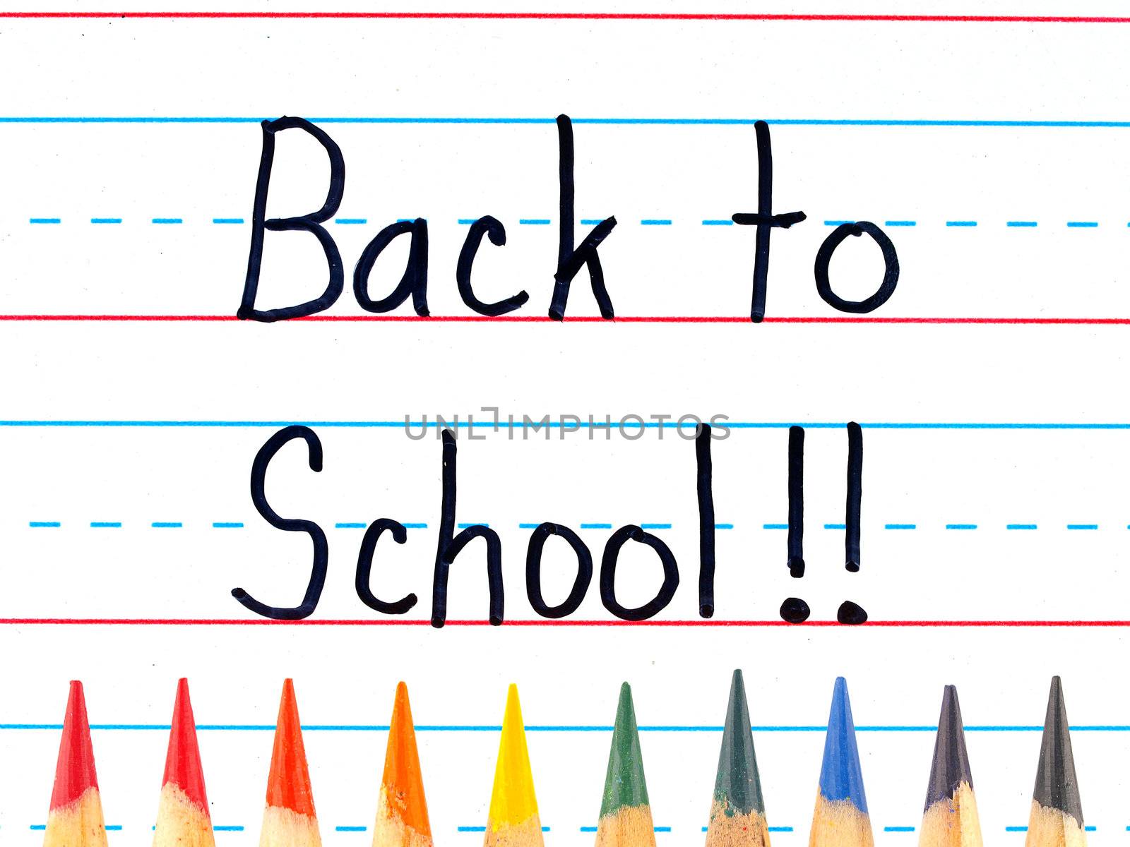 Back to School Written on a Lined Dry Erase Board with Colored Pencils