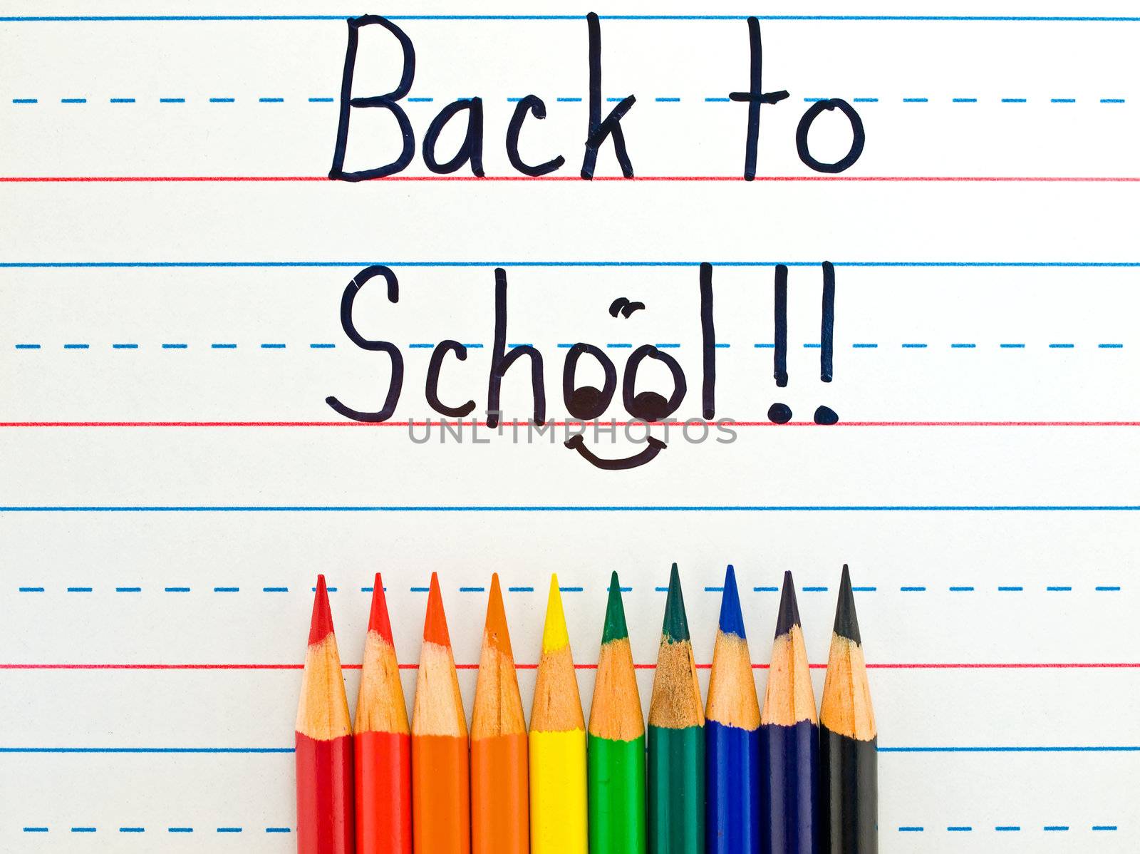 Back to School Written on a Lined Dry Erase Board with Colored Pencils