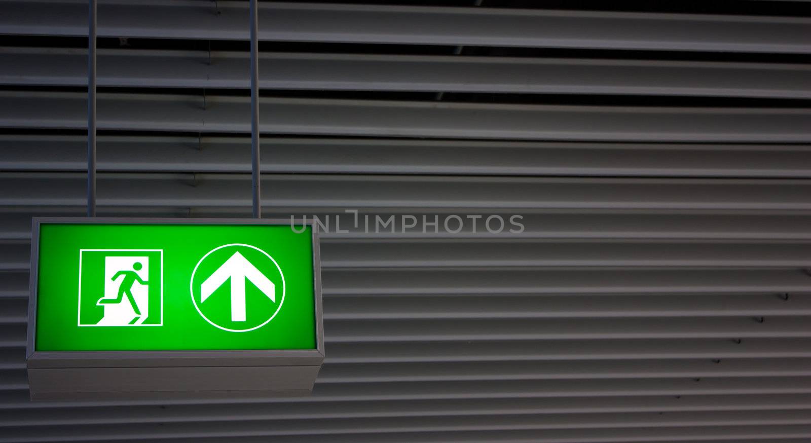 Emergency exit sign in modern offices inside an industrial plant