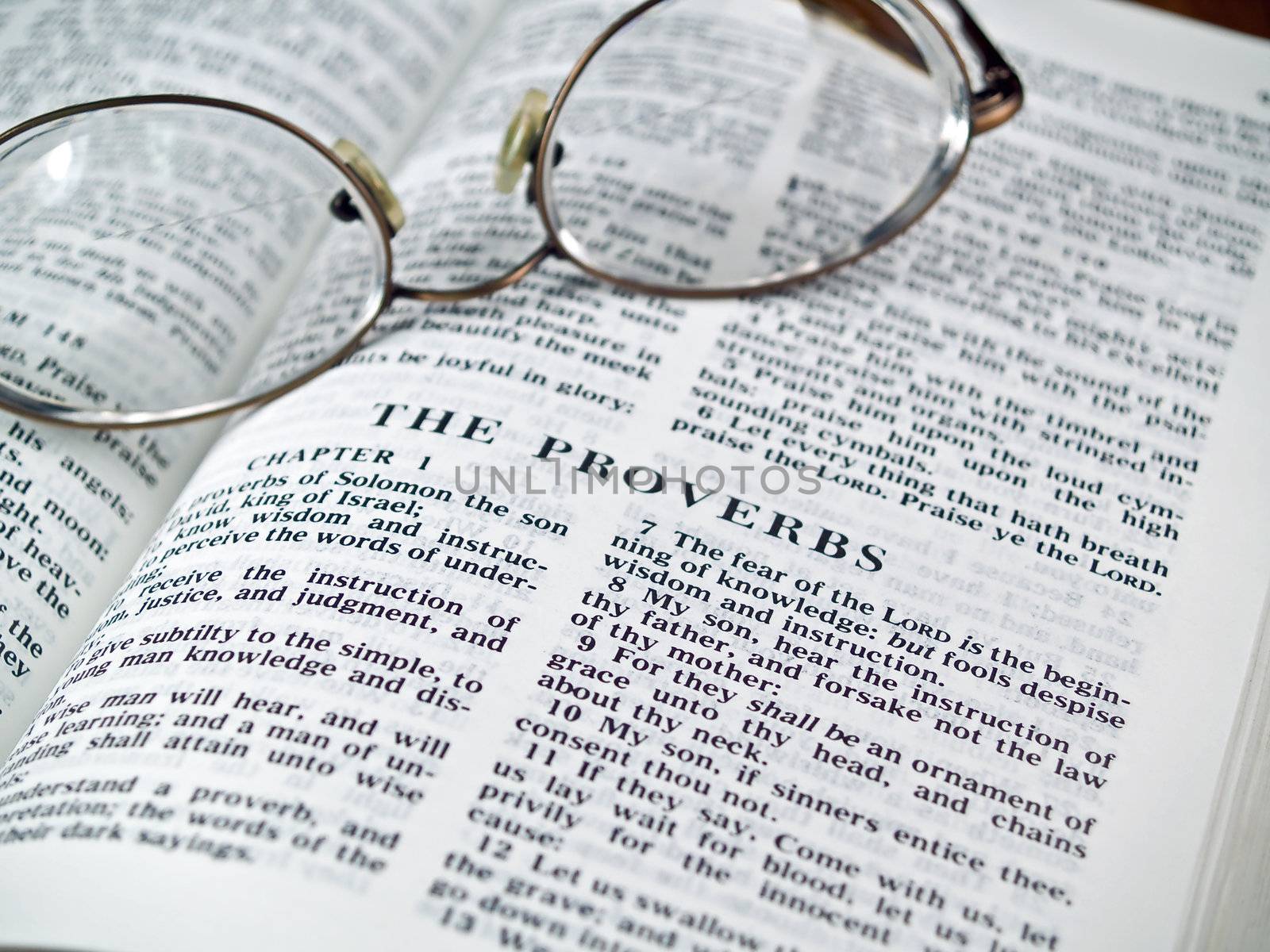 The Bible opened to the Book of Proverbs with Glasses by Frankljunior