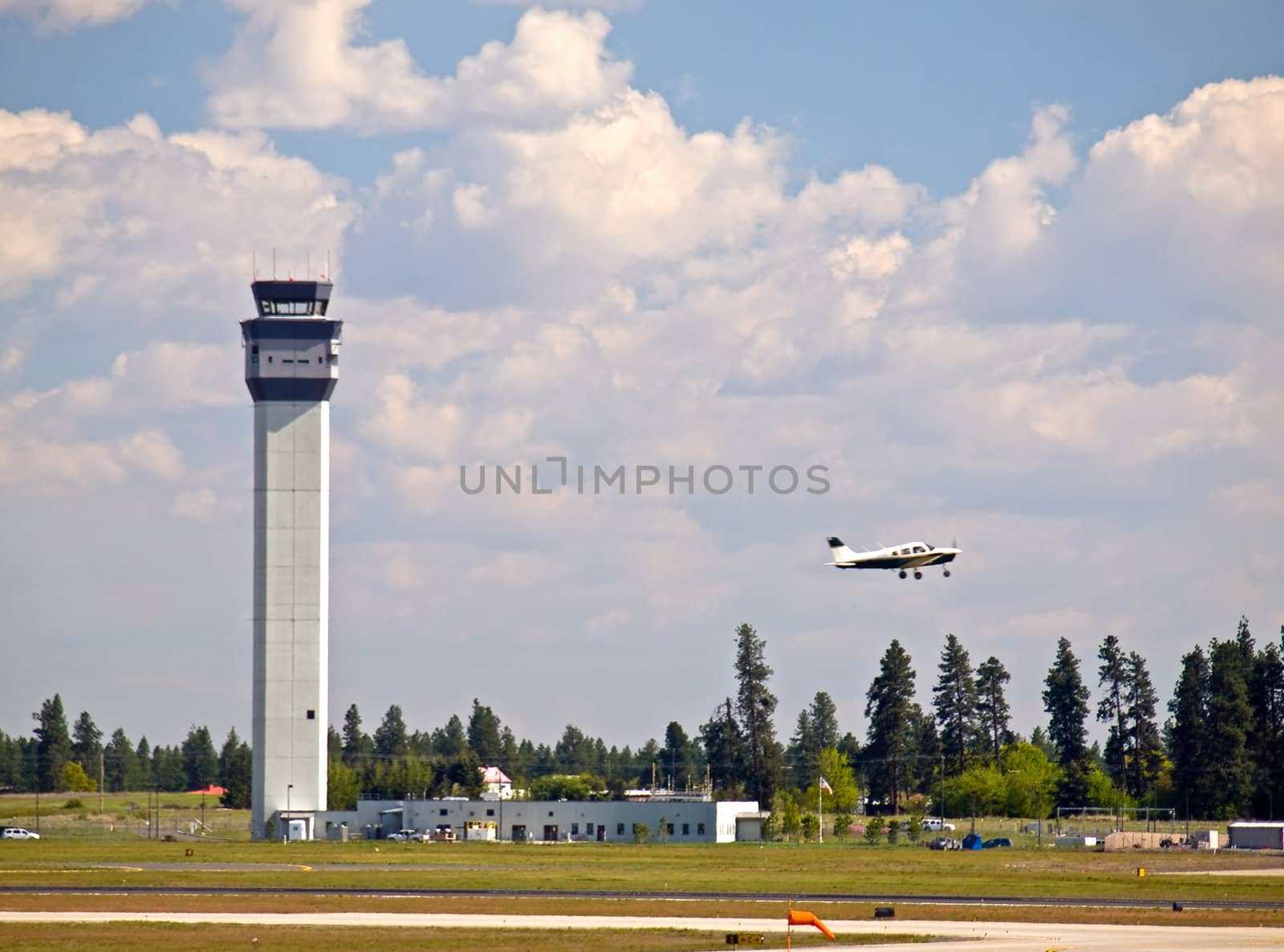 Air Traffic Control Tower of a Modern Airport with Aircraft Taking Off