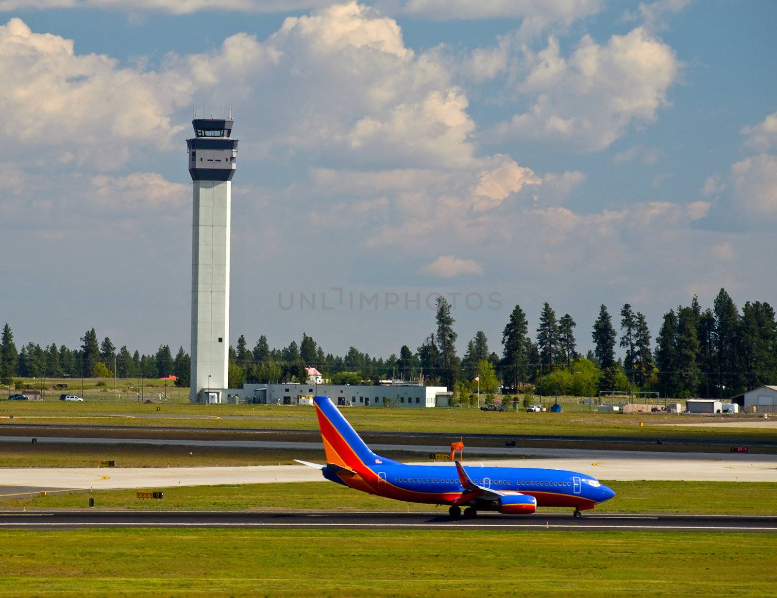 Air Traffic Control Tower and an Airplane on the Taxiway