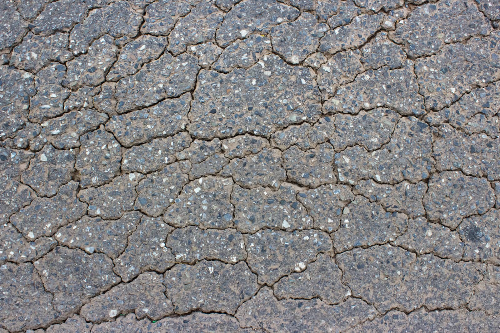 Macro closeup on concrete asphalt cracks on the road