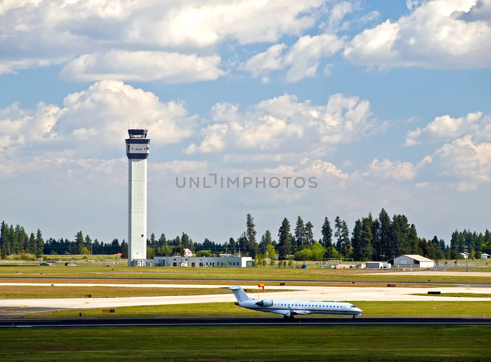 Air Traffic Control Tower of a Modern Airport with Aircraft Taking Off