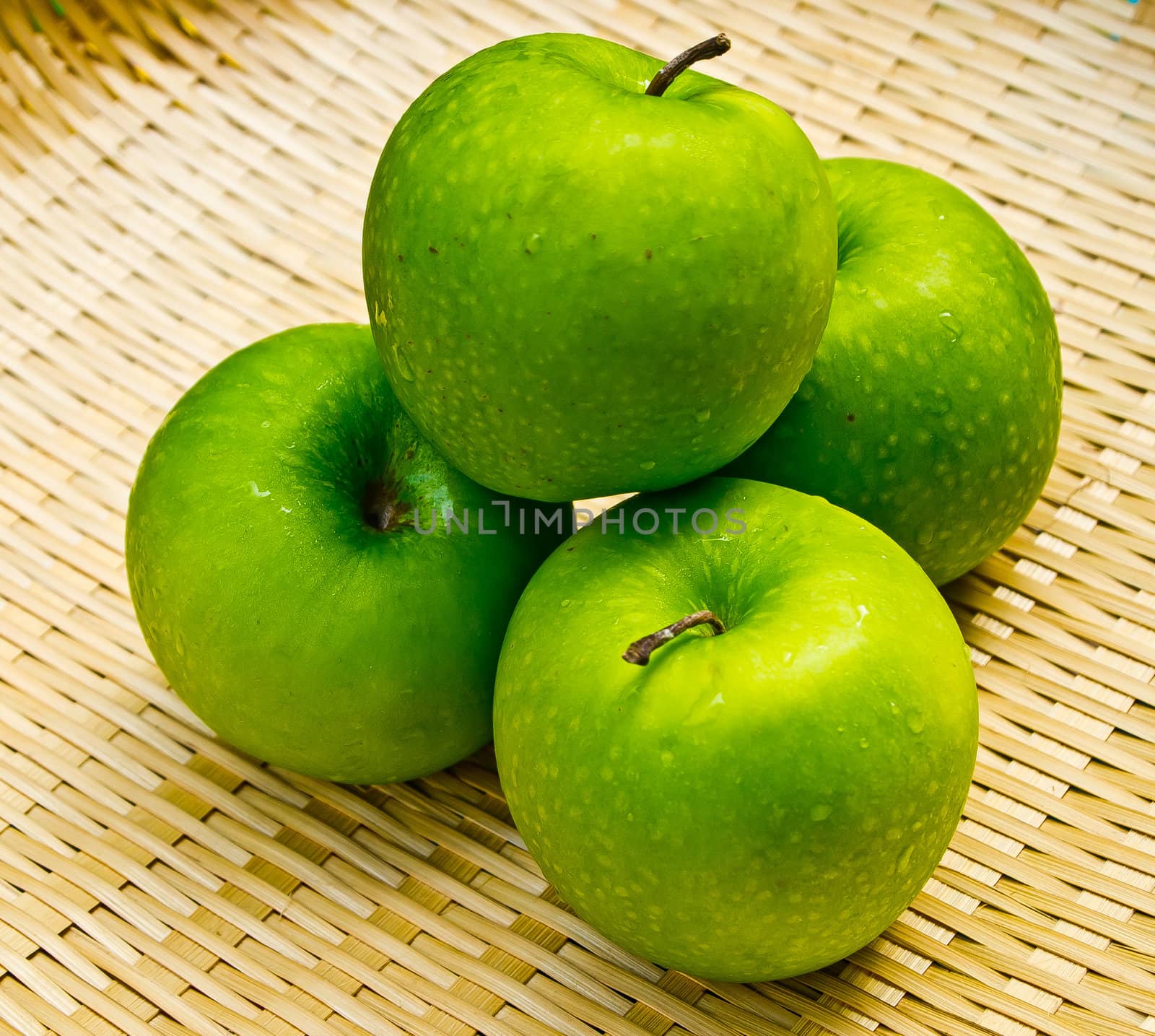 Green apple on basketwork