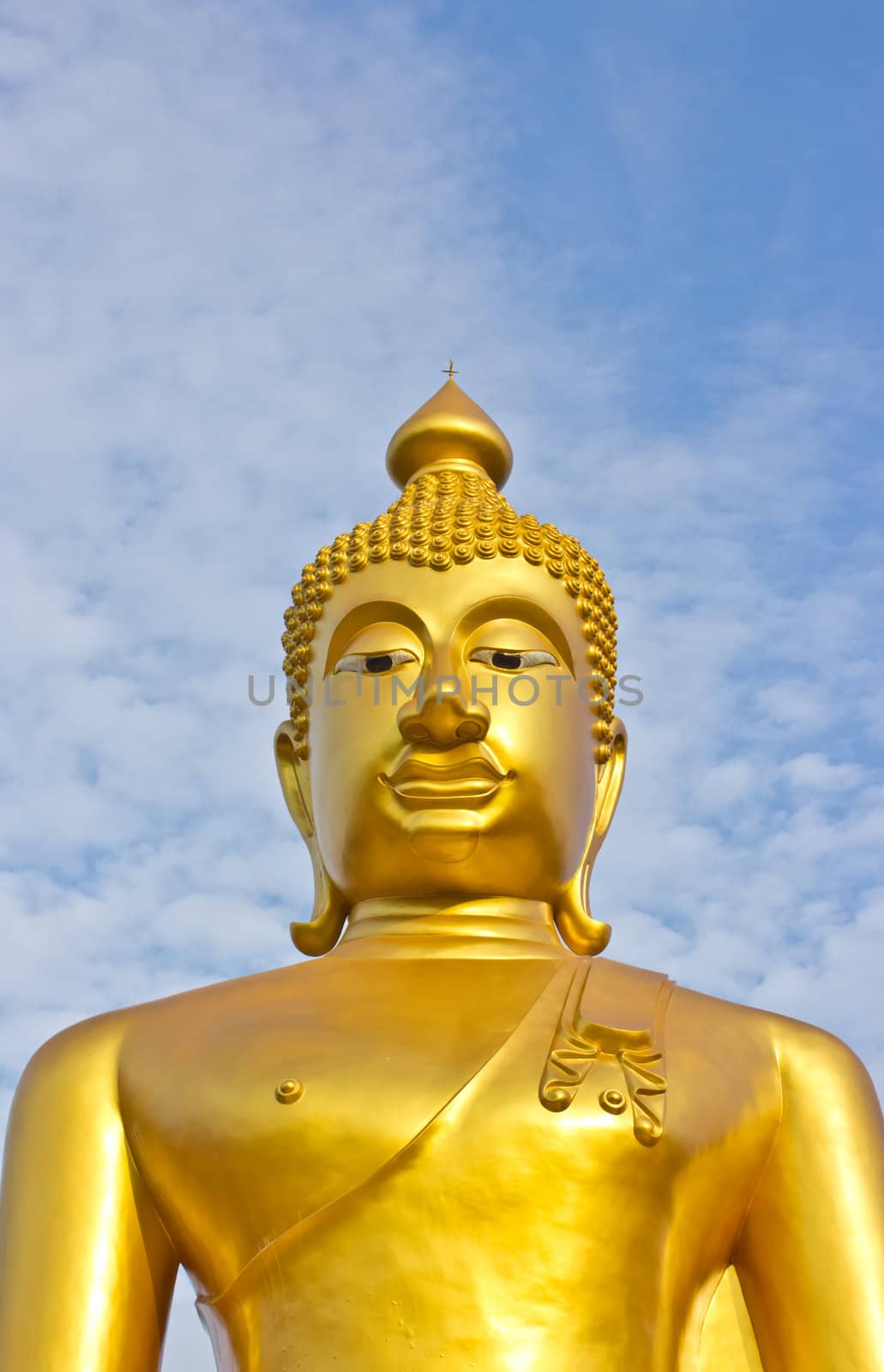 Golden Buddha statue in a Buddhist temple and blue sky