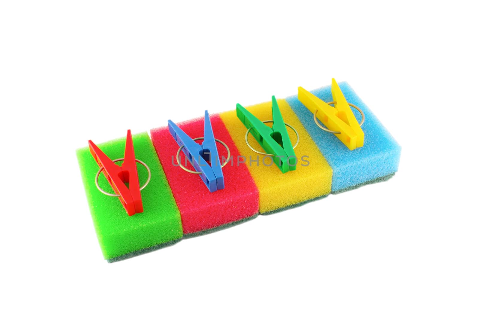 Color sponges and clothes-pegs over white