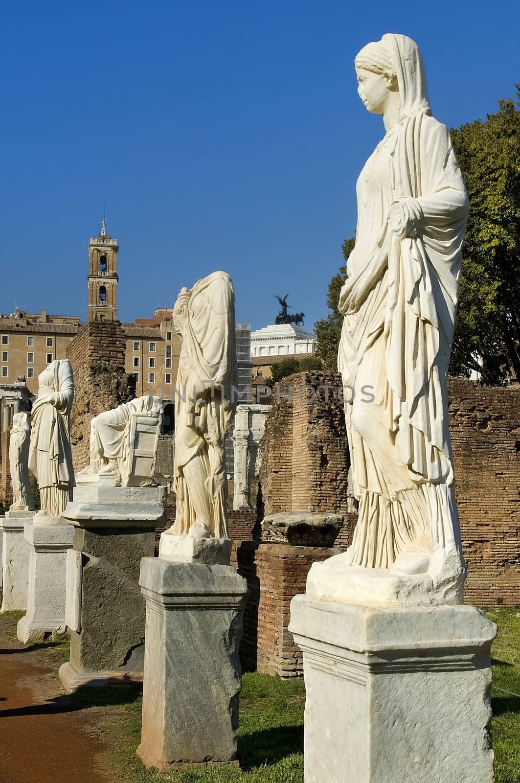 Ancient Roman statues on pedestals by irisphoto4