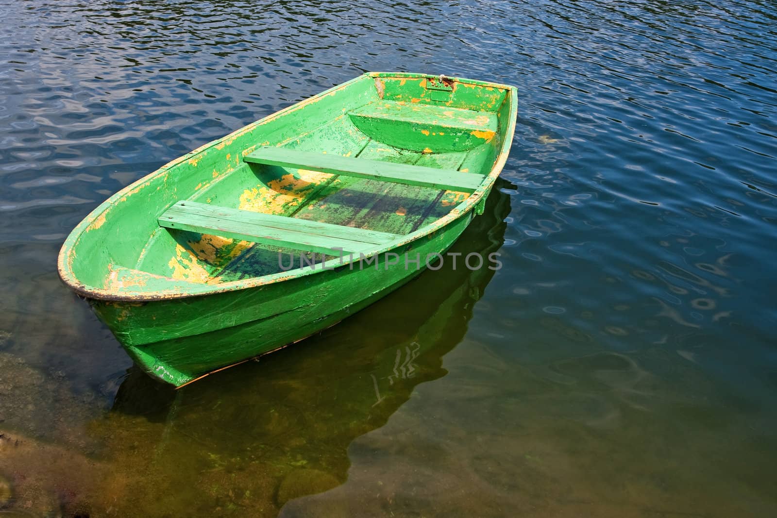 Grunge rowing boat on lake by Verdateo