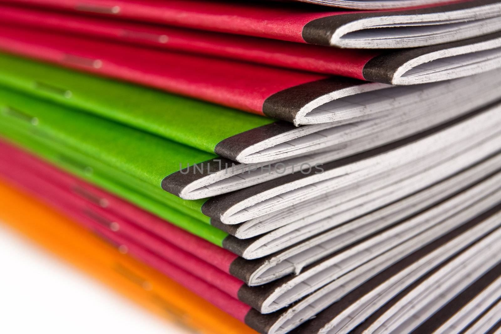 Stack of color notebooks on white background