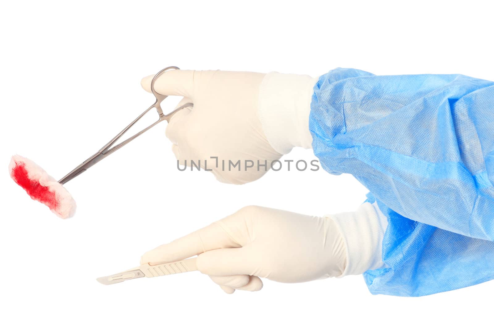 scalpel and clamp with swab in the hand of the surgeon during a surgery