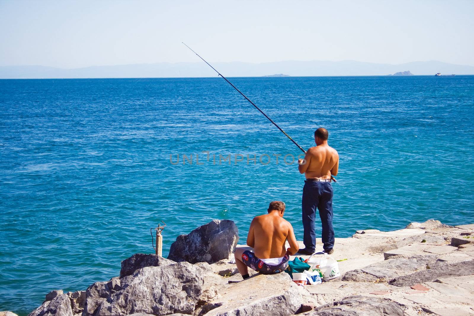 two men fishing in bosphorus, istanbul, Turkey