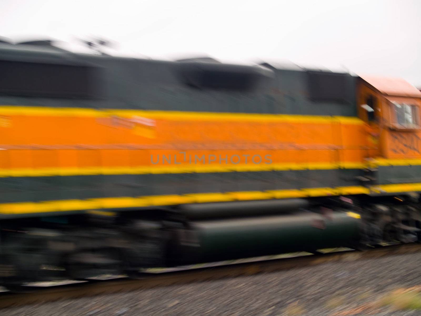 Blurred moving cargo trains from a train road crossing