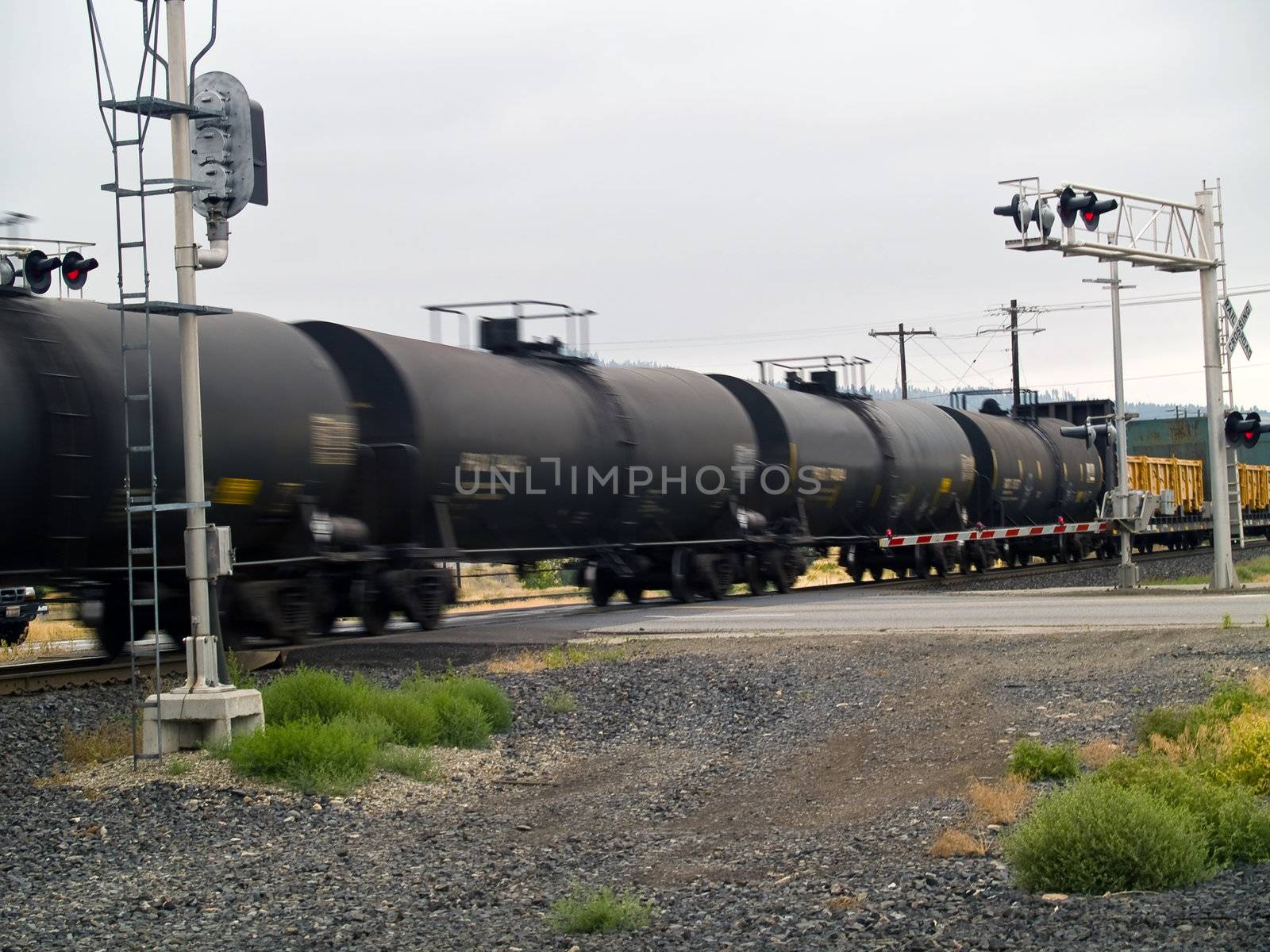 Blurred moving cargo trains from a train road crossing