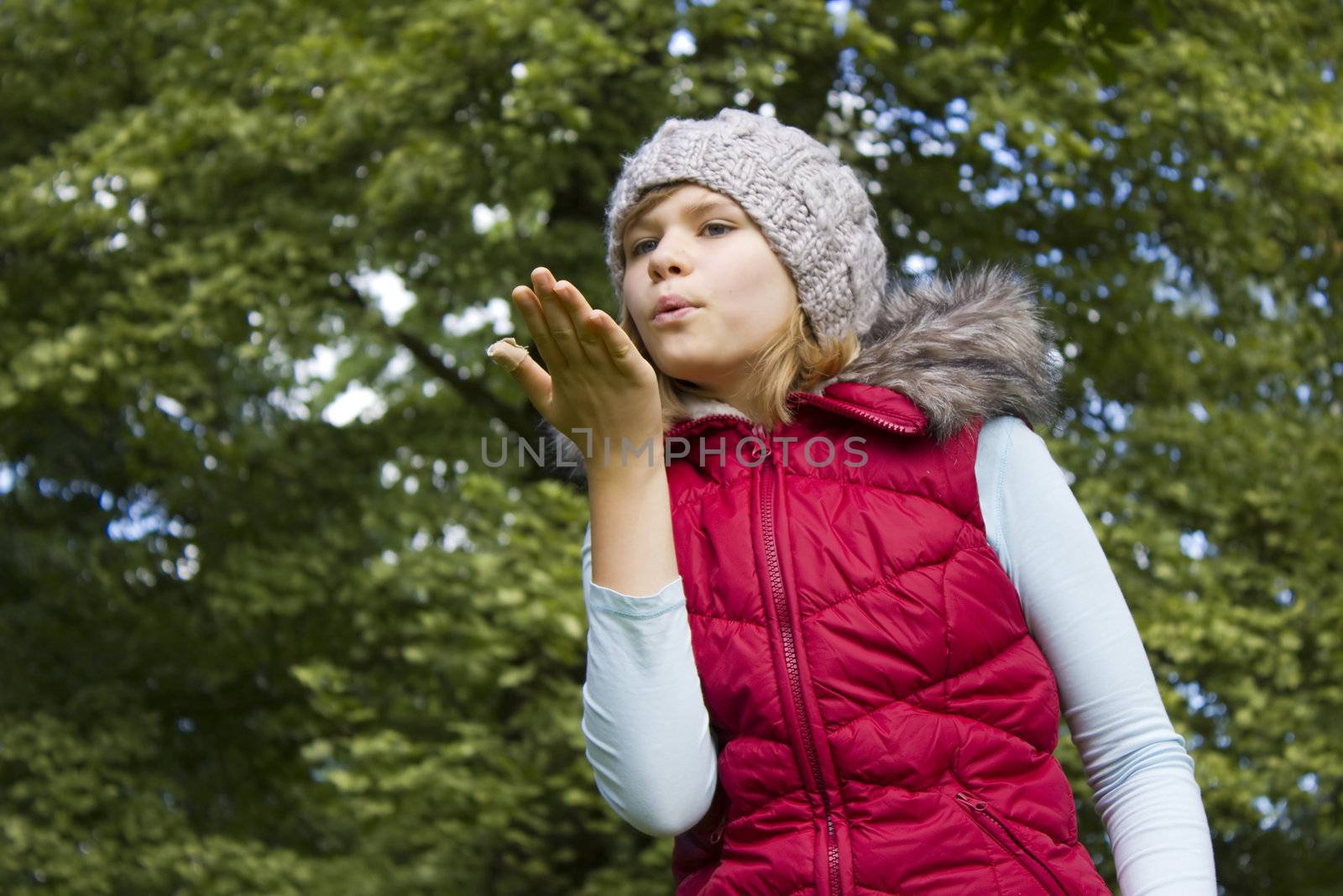 young girl blowing wind with lips