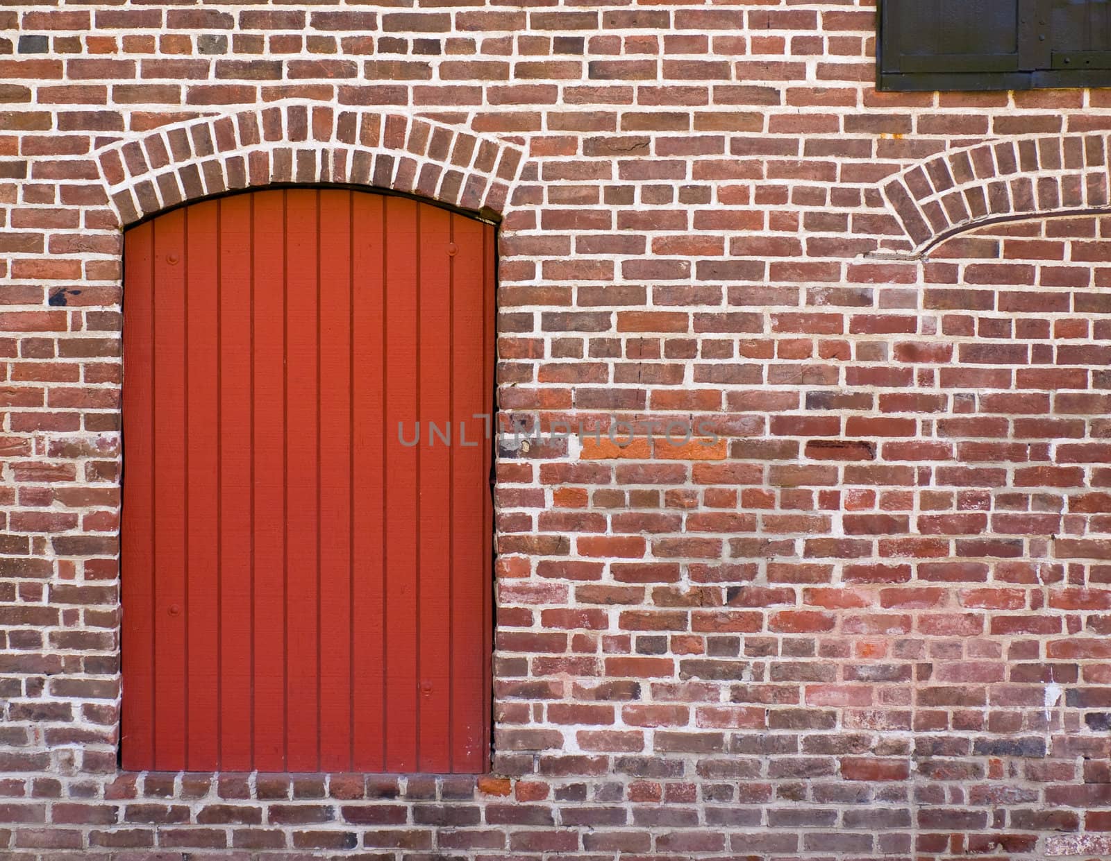 Red Brick Wall with a Red Door and Window by Frankljunior