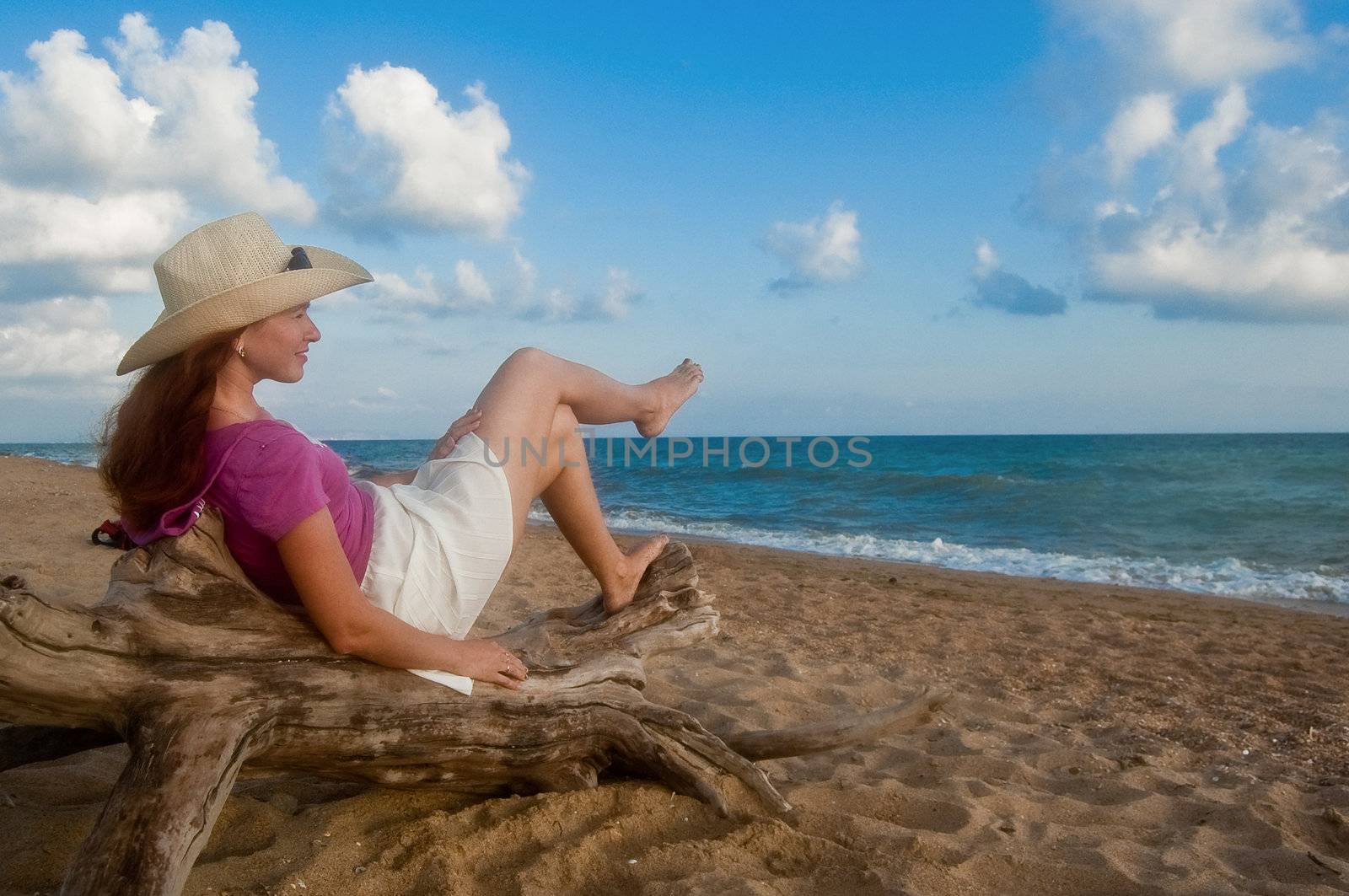 Woman on the sandy beach at sunset