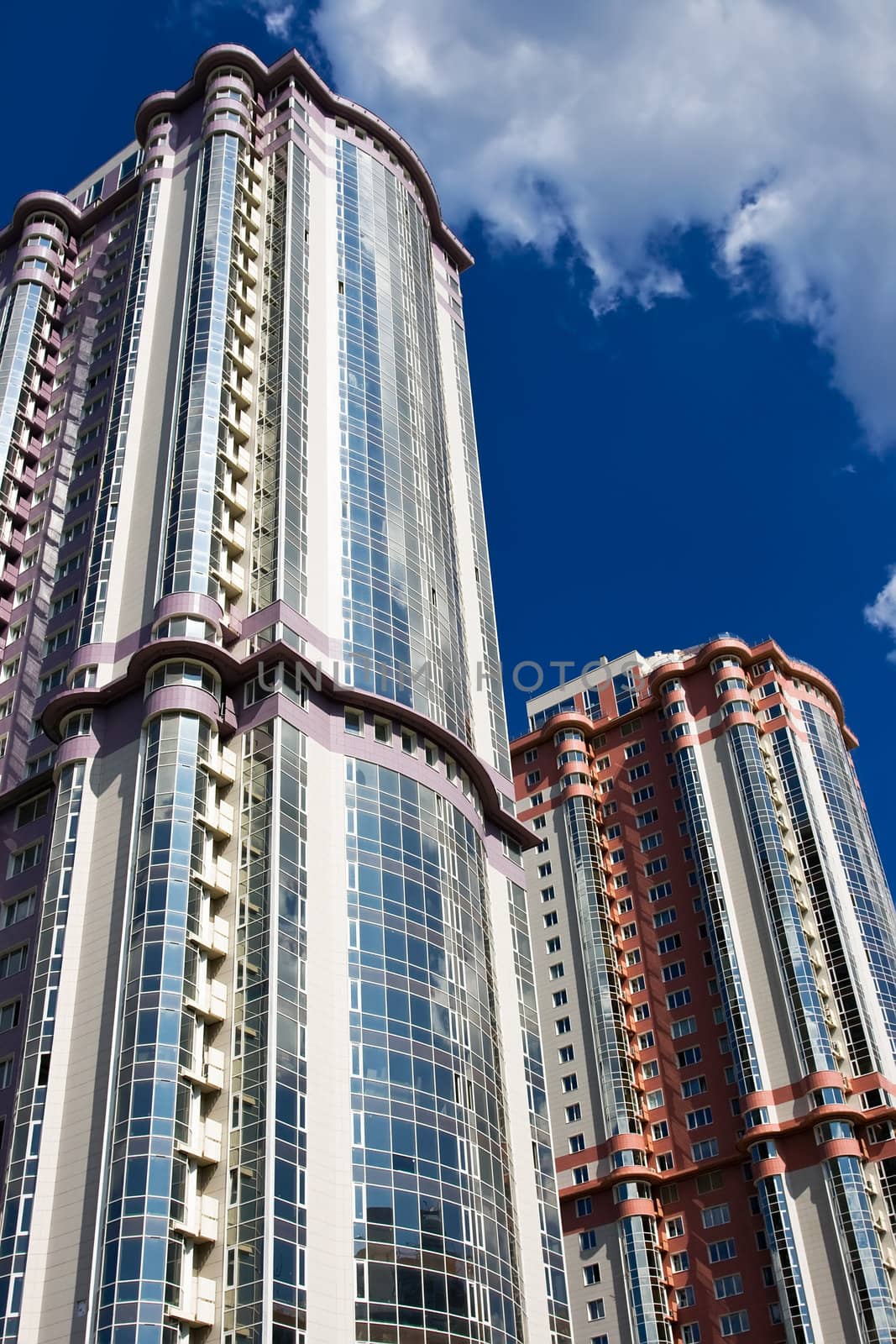 High modern apartment buildings under blue sky